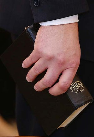 Ed Husic holding Koran